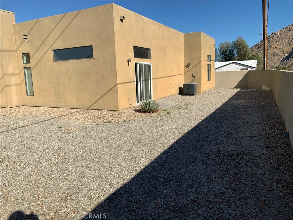 60055 Overture Drive Palm Springs, CA 92262 - Photo 14 of 19 a view of a parking space in front of a building