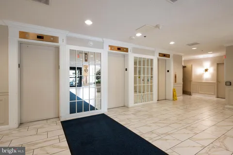 a view of a hallway with wooden shelves