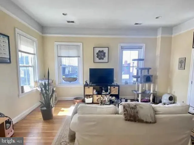 a living room with fireplace furniture and a window