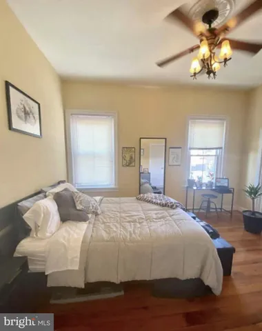 a bedroom with a large bed and a chandelier
