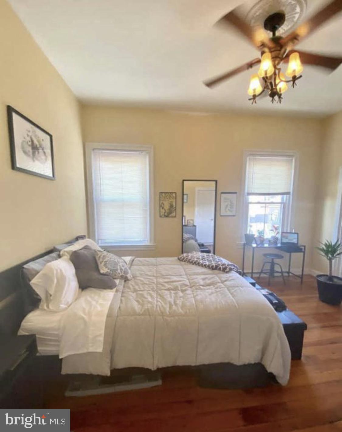 101 Fayette Street, Unit 3 Conshohocken, PA 19428 - Photo 15 of 22 a bedroom with a bed and a chandelier