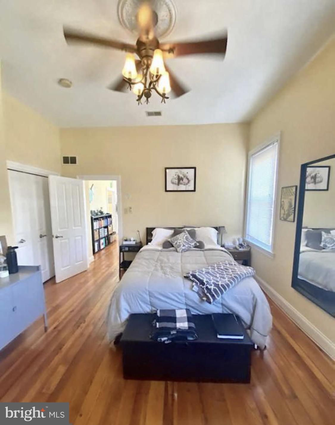 101 Fayette Street, Unit 3 Conshohocken, PA 19428 - Photo 16 of 22 a bedroom with a large bed and a chandelier