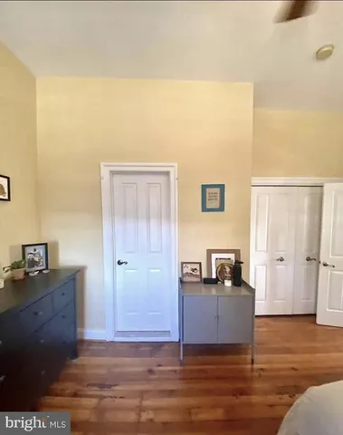 a bathroom with a toilet a sink a mirror and vanity