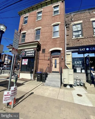 a building with table and chairs in front of building