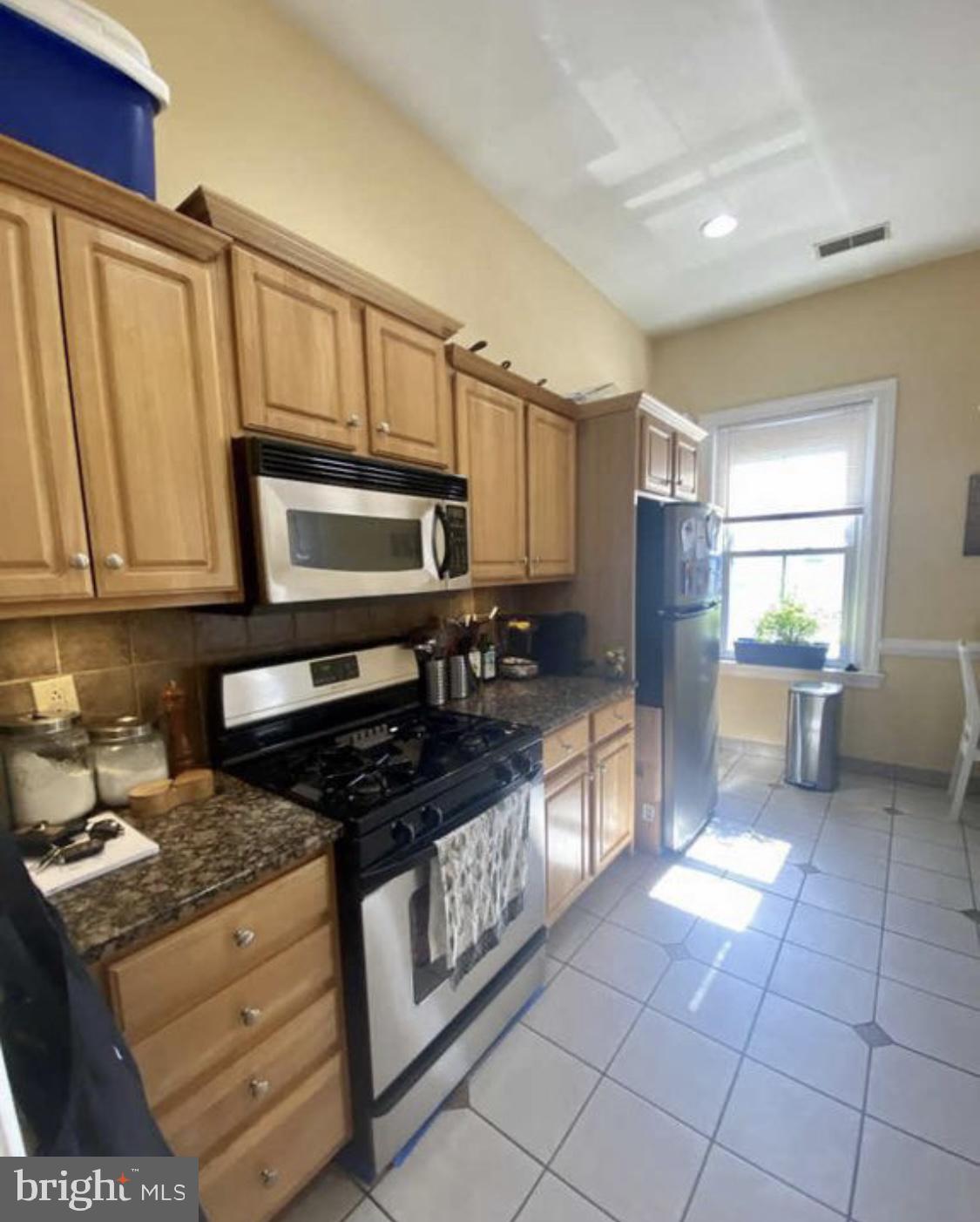 101 Fayette Street, Unit 3 Conshohocken, PA 19428 - Photo 7 of 22 a kitchen with stainless steel appliances granite countertop a stove a refrigerator and a microwave