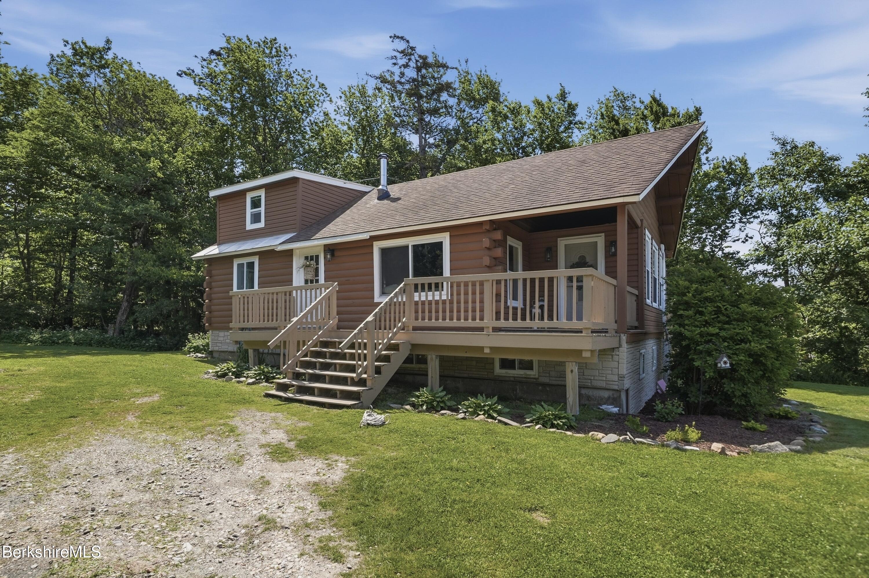 4 David Drive Peru, MA 01235 - Photo 5 of 44 a front view of a house with a garden