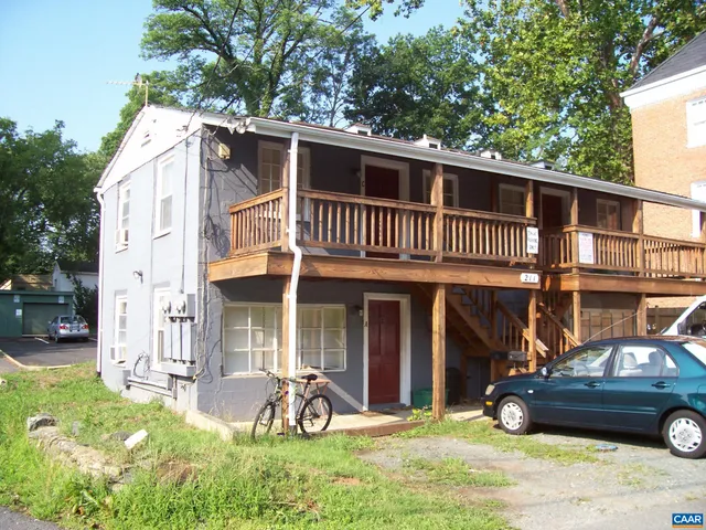 a view of a house with a patio and a yard