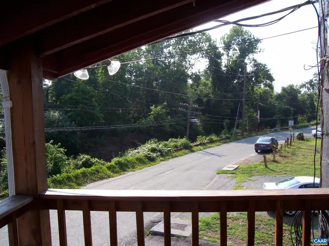 a view of backyard with a lake and trees in the background