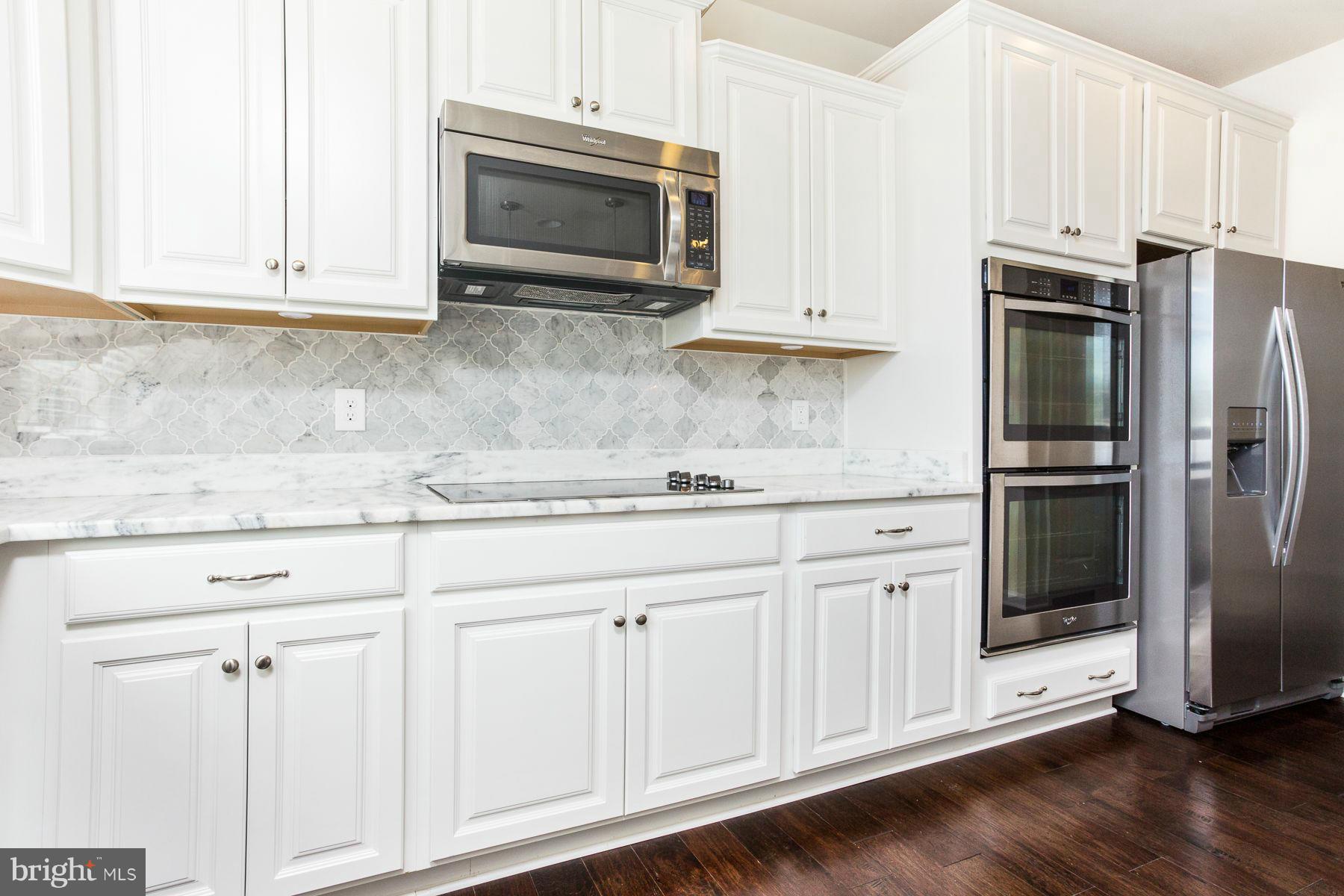 23 Tankard Road Stafford, VA 22554 - Photo 3 of 29 a kitchen with granite countertop white cabinets and stainless steel appliances