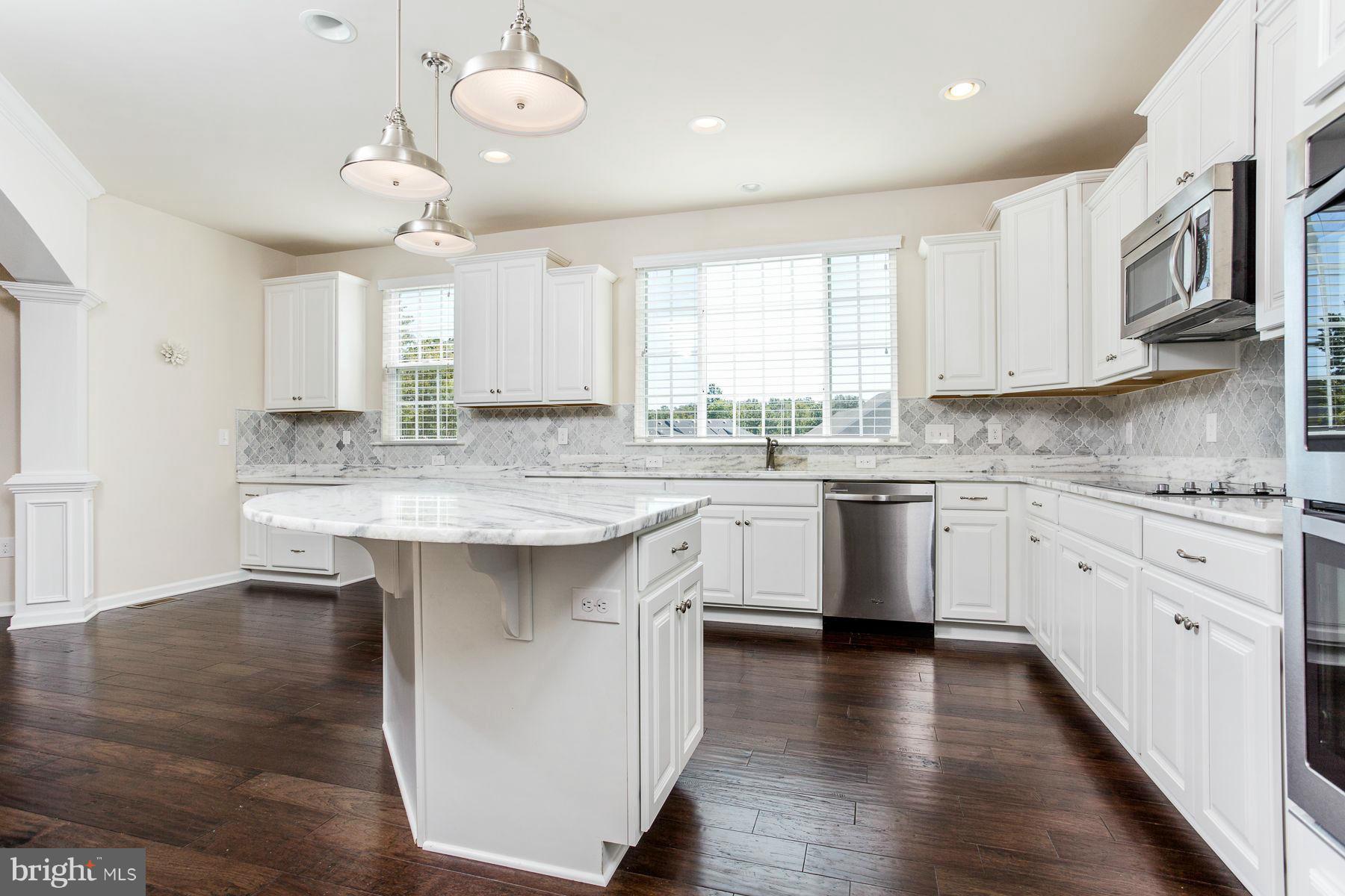 23 Tankard Road Stafford, VA 22554 - Photo 4 of 29 a kitchen with stainless steel appliances granite countertop a sink cabinets a wooden floor and a window