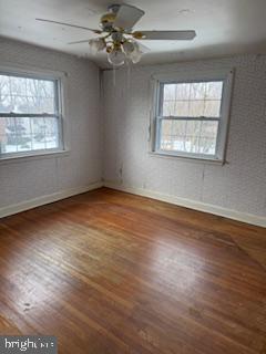 493 Wheatsheaf Road Springfield, PA 19064 - Photo 18 of 25 an empty room with wooden floor chandelier and windows