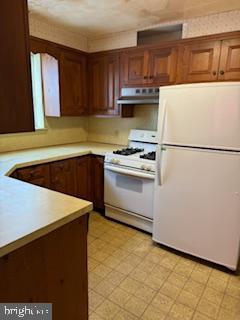 493 Wheatsheaf Road Springfield, PA 19064 - Photo 8 of 25 a kitchen with a refrigerator sink and cabinets