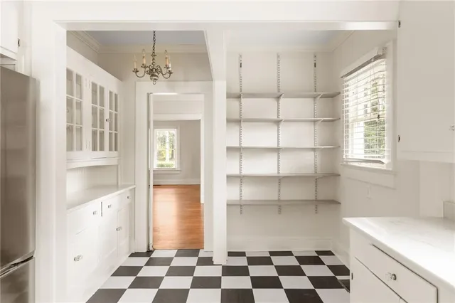 a room with a black white checkered floor with a black white checkered floor and a window