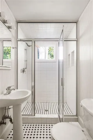 a bathroom with a sink toilet and shower