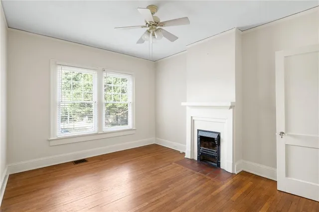 wooden floor fireplace and natural light in room