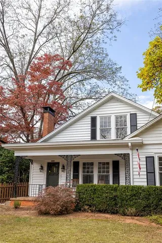 a front view of a house with swimming pool and glass windows