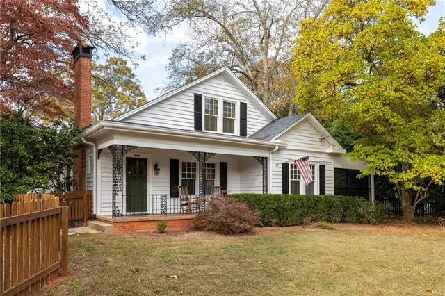 a front view of a house with yard and green space