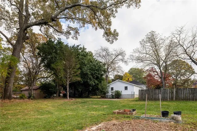 a view of a house with a yard and tree s