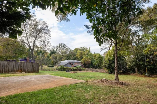 a white house with a trees in the background