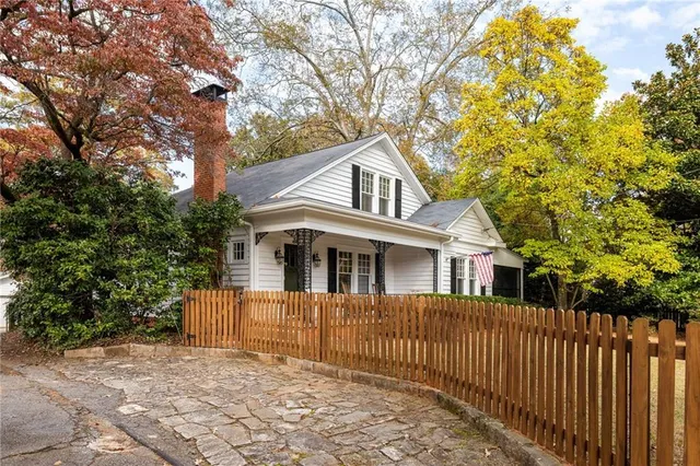 a front view of a house with a tree