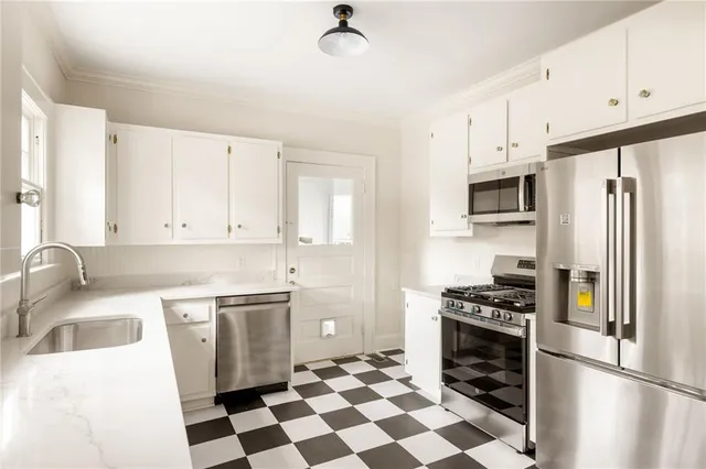 a kitchen with a stove a refrigerator and a sink