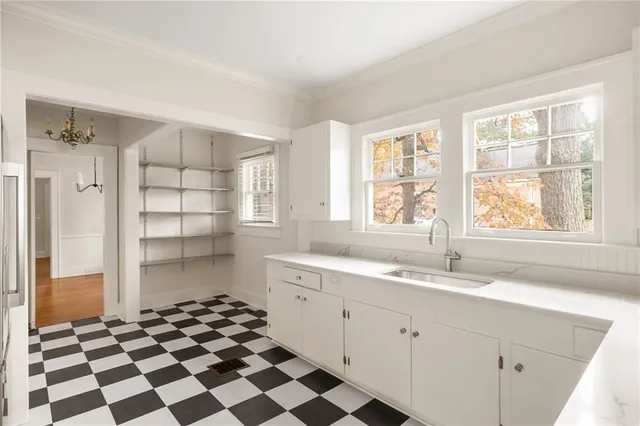 a kitchen with a checkered floor and a window