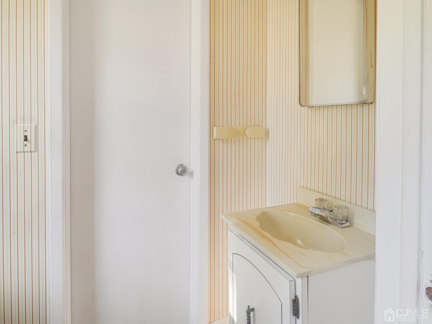 29 Princeton Road Cranford, NJ 07016 - Photo 18 of 24 a bathroom with a sink and a mirror