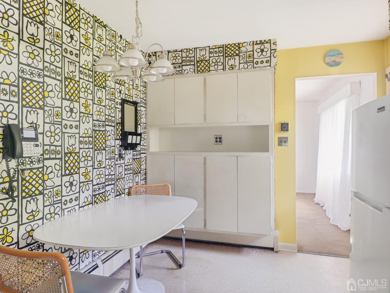 29 Princeton Road Cranford, NJ 07016 - Photo 6 of 24 a bathroom with a table and a refrigerator