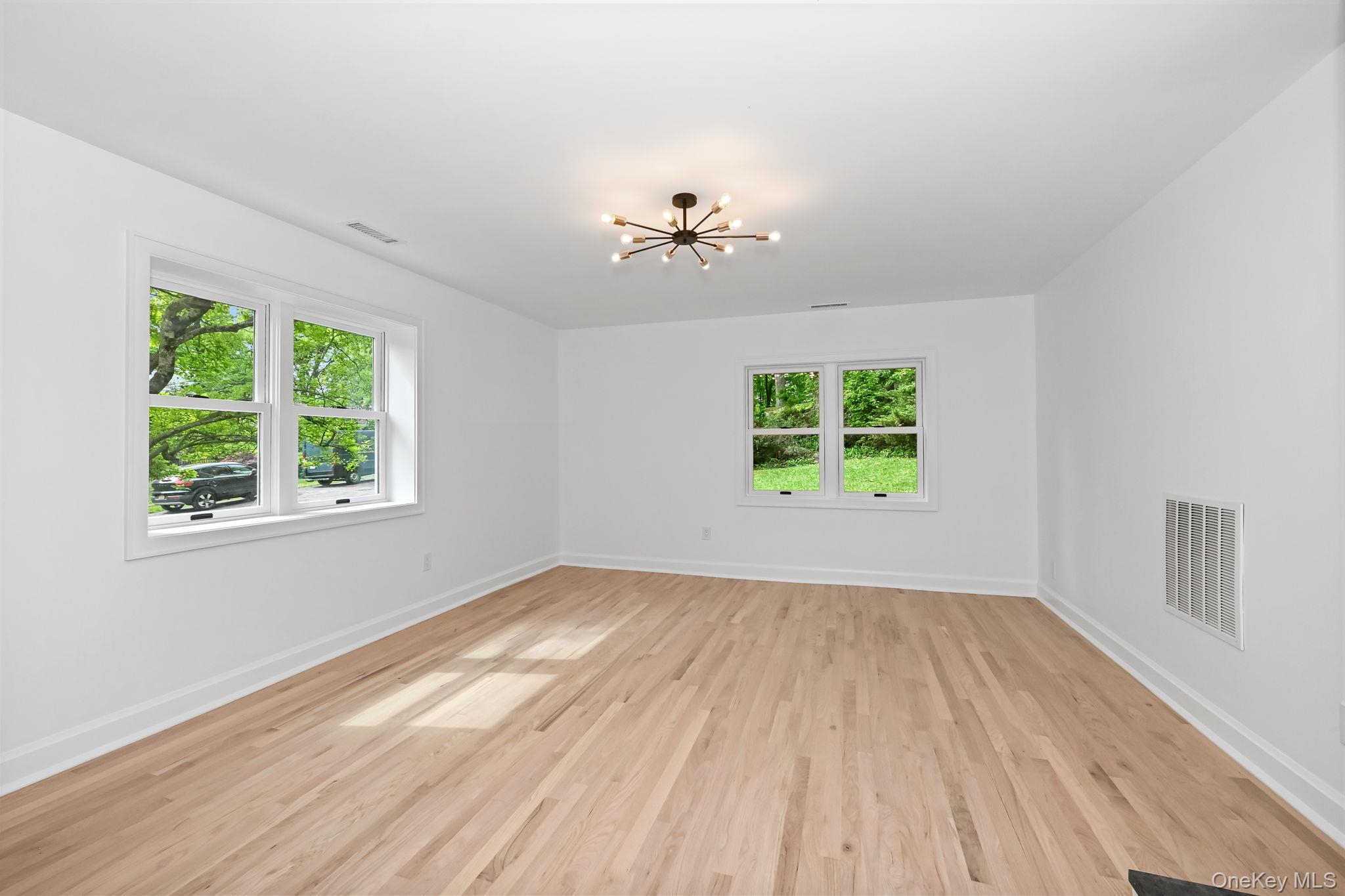 24 Country Road Mamaroneck, NY 10543 - Photo 12 of 37 wooden floor in an empty room with a window
