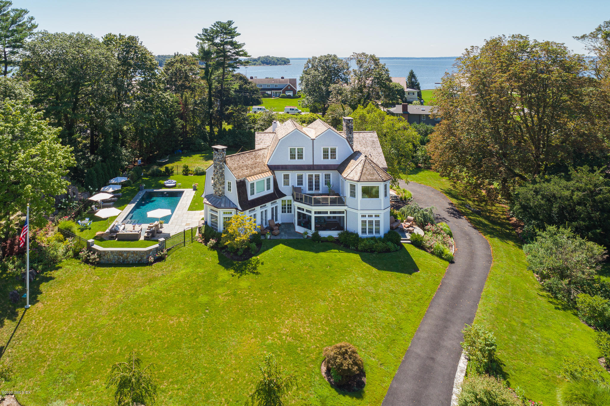 a view of a house with pool and chairs
