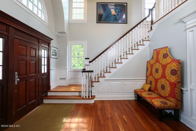 a view of entryway and hall with wooden floor