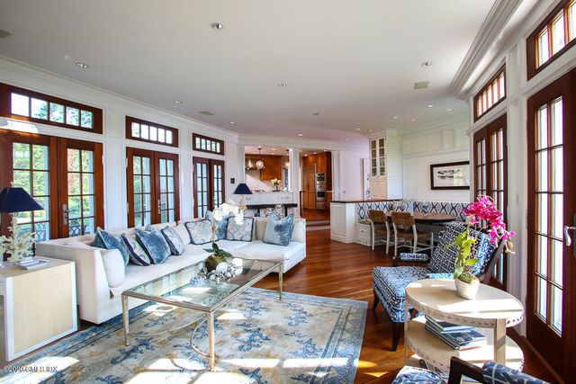 a living room with furniture fireplace and a large window