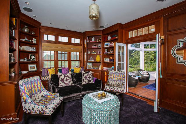 a living room with furniture and a floor to ceiling window