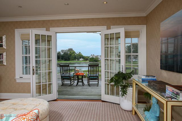 a balcony with furniture and a potted plant