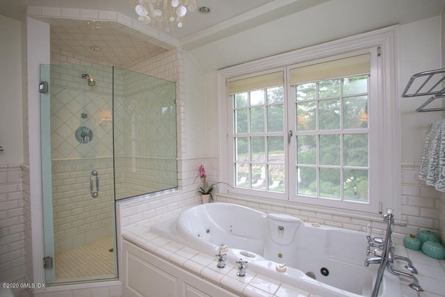 a bathroom with a bathtub and a shower
