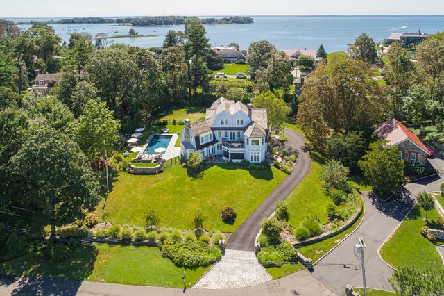an aerial view of a house with swimming pool outdoor seating and yard