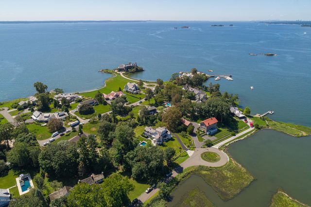 a view of a lake with boats and trees in the background