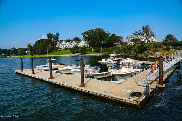 a kitchen with stainless steel appliances granite countertop a sink a stove and a wooden floors
