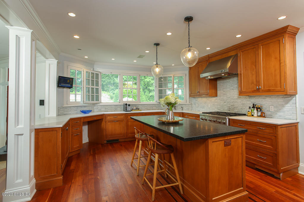 22 Cherry Tree Lane Riverside, CT 06878 - Photo 38 of 50 a kitchen with stainless steel appliances granite countertop a sink a stove and a wooden floors