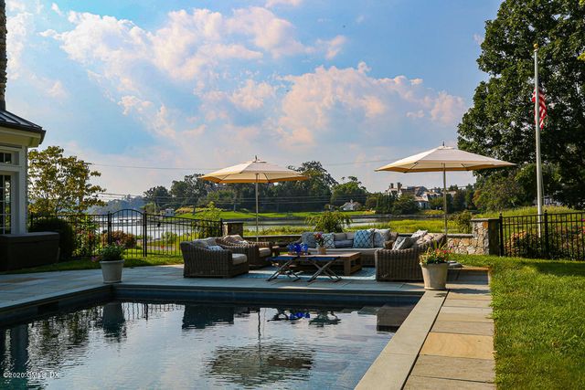 a view of a swimming pool with outdoor seating and plants