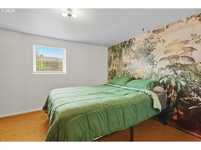 a bedroom with a bed with wooden floor