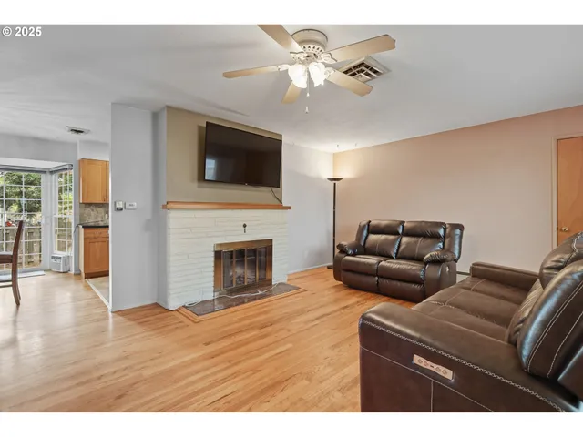 a living room with furniture fireplace and flat screen tv