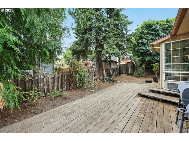 a view of a house with a yard and fence