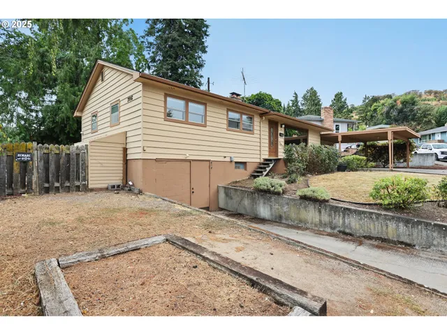 a front view of a house with a yard and a garage