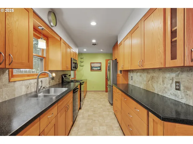 a kitchen with kitchen island granite countertop a sink and cabinets