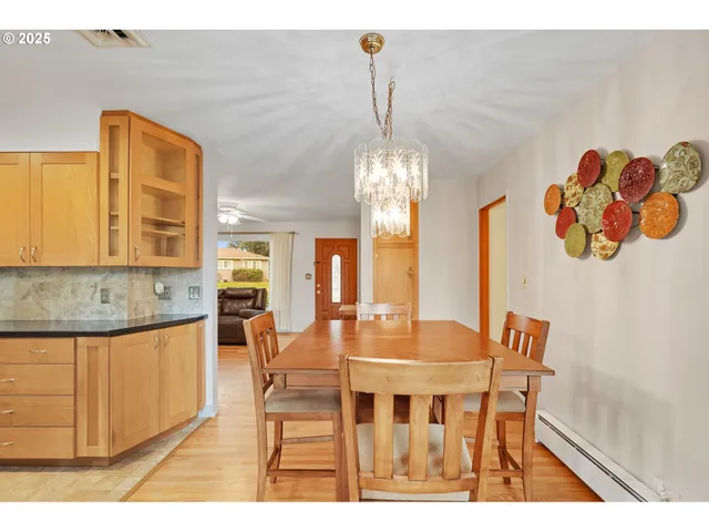 a view of a dining room with furniture and chandelier