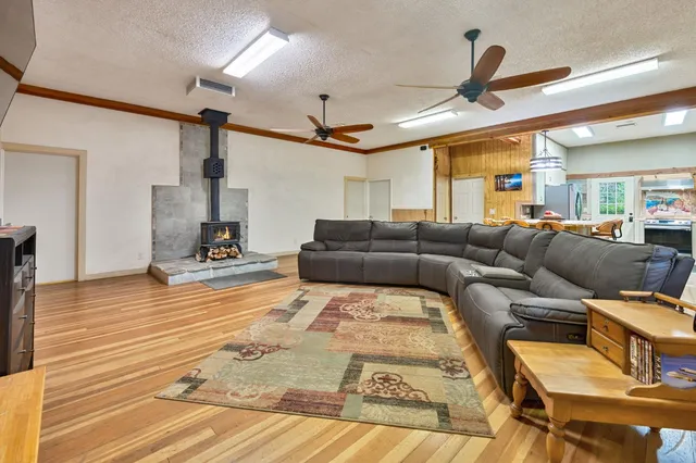 a view of a dining room with furniture and a kitchen