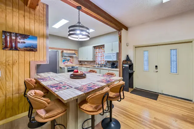 a kitchen with stainless steel appliances a stove a sink and a refrigerator