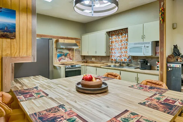 a kitchen with stainless steel appliances granite countertop a refrigerator and a sink