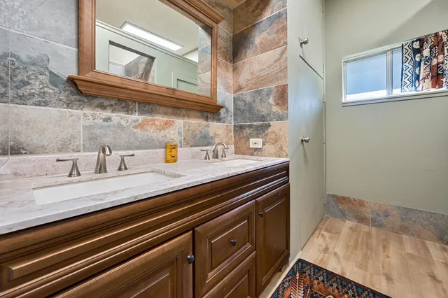 a bathroom with a shower and a sink